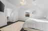Bedroom featuring vaulted ceiling, recessed lighting, a chandelier, and dark wood finished floors
