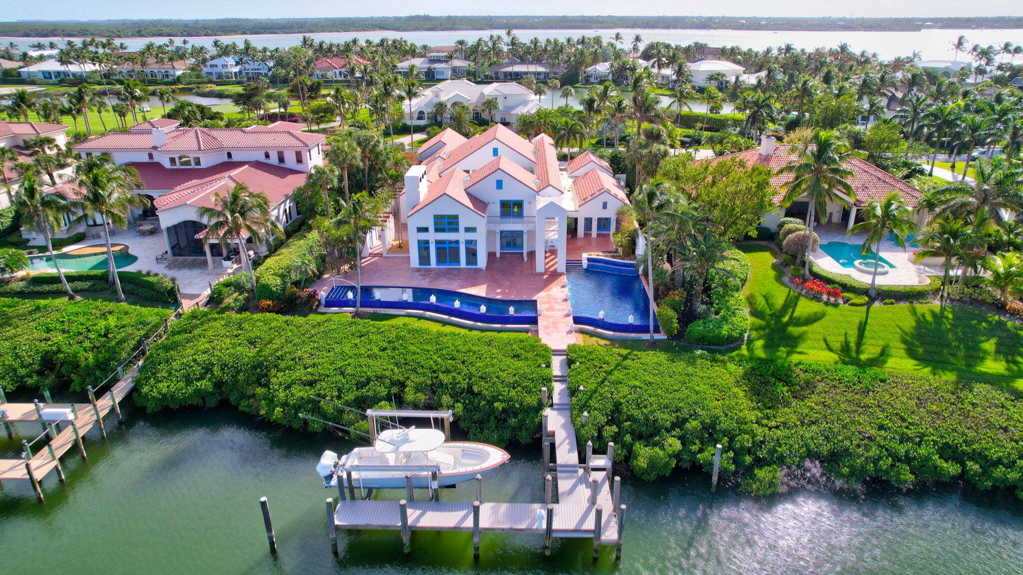 At the intersection of architecture, nature, and water lies this unparalleled estate in the exclusive community of Sailfish Point.