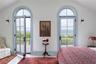 Bedroom with vaulted ceiling, multiple windows, access to exterior, and tile patterned floors