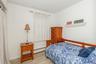Bedroom featuring a baseboard radiator, wood finished floors, and baseboards