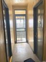 Hall featuring tile patterned floors and baseboards