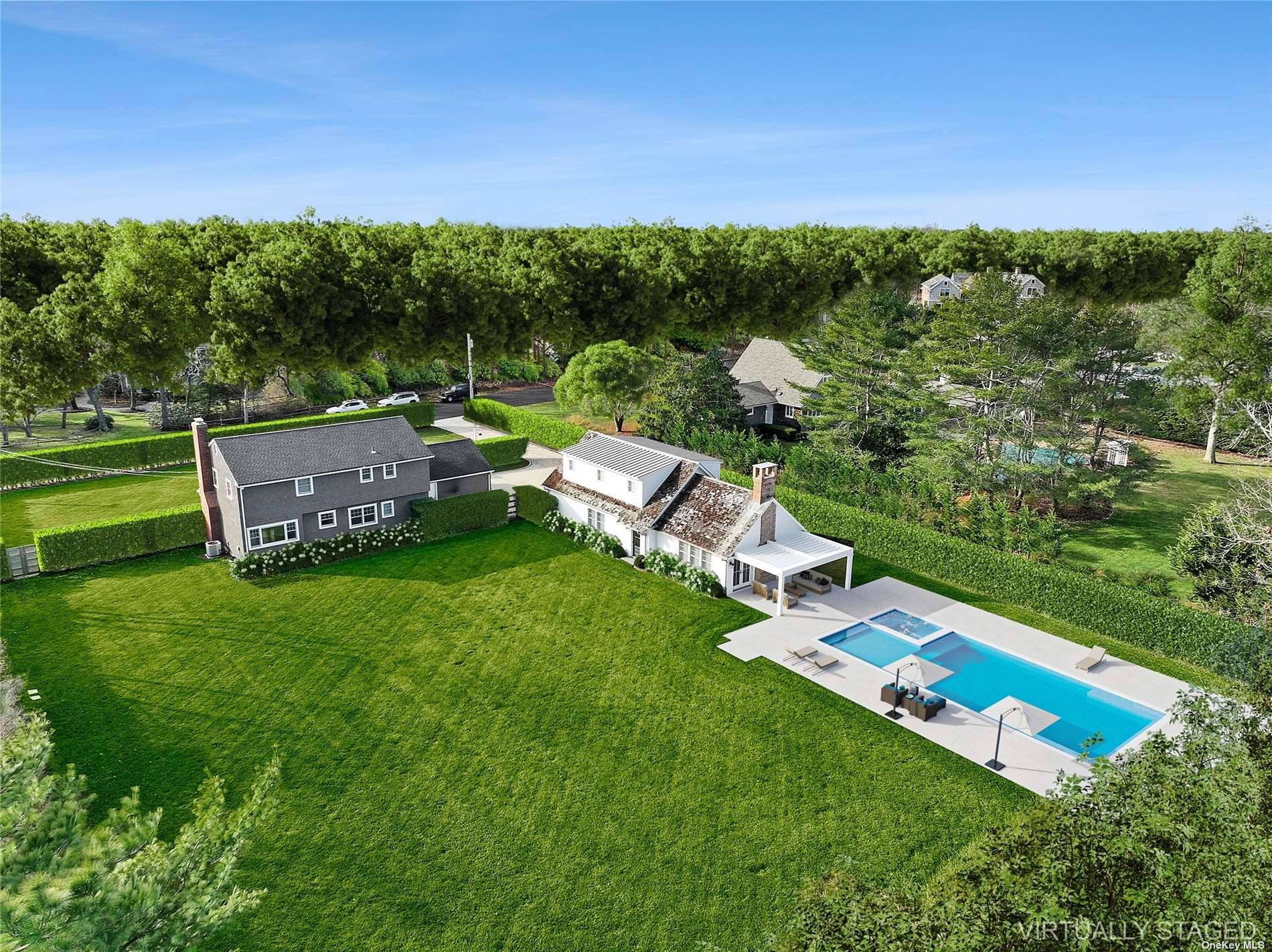 Located down a quiet cul de sac lane in the bucolic hamlet of Remsenburg, this classic Hamptons Farmhouse stands tall on a privately hedged acre, fully fenced and beautifully landscaped.