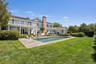 Rear view of property with a patio, a lawn, a chimney, an outdoor pool, and french doors