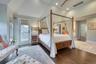 Primary suite feature soaring cathedral ceilings and private balcony