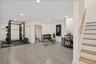 virtually staged gym set up/area as you step into the basement