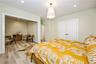 Bedroom featuring light wood finished floors, a closet, a desk, recessed lighting, and baseboards
