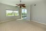 Primary bedroom with slider to lanai and hurricane shutters