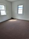 Unfurnished room with plenty of natural light and carpet floors