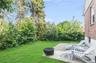 View of grassy yard featuring a fire pit and a patio area