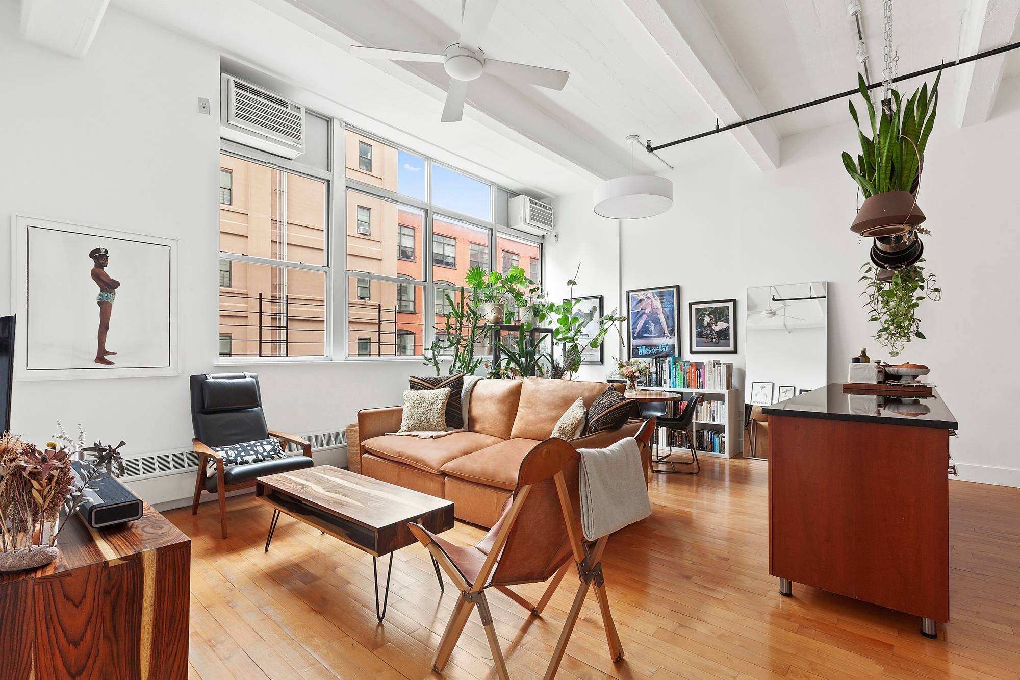 A voluminous two bedroom, two bathroom loft with palatial poured concrete beamed ceilings in a full service Clinton Hill condominium.