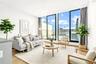 Living area with light wood-style floors and floor to ceiling windows