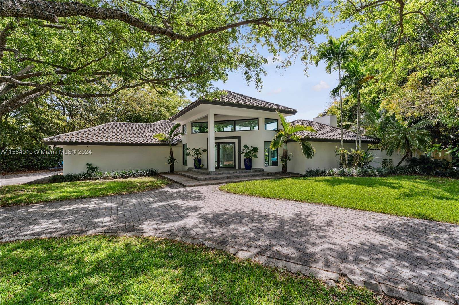Step into this exquisite 7 bed 4 bath residence, boasting 5002 sqft of living space, set on a sprawling 31363 sqft lot, adorned with marble floors, vaulted ceilings, hurricane impact ...