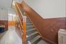 Stairway featuring a wainscoted wall