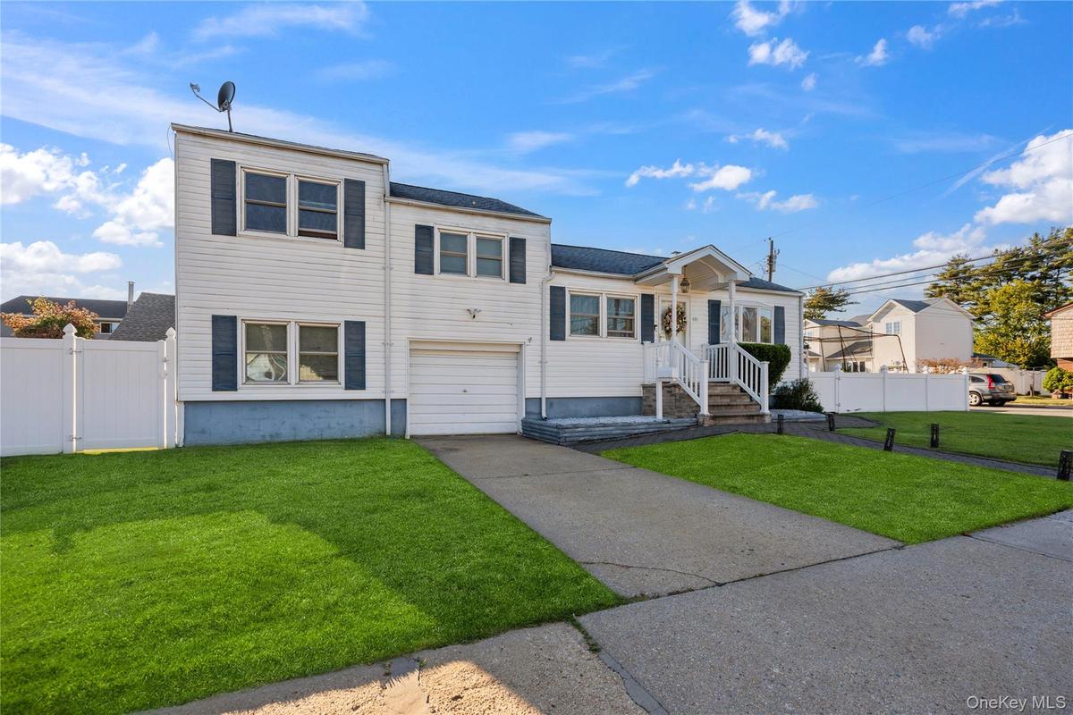 View of front of house with an attached garage and concrete driveway
