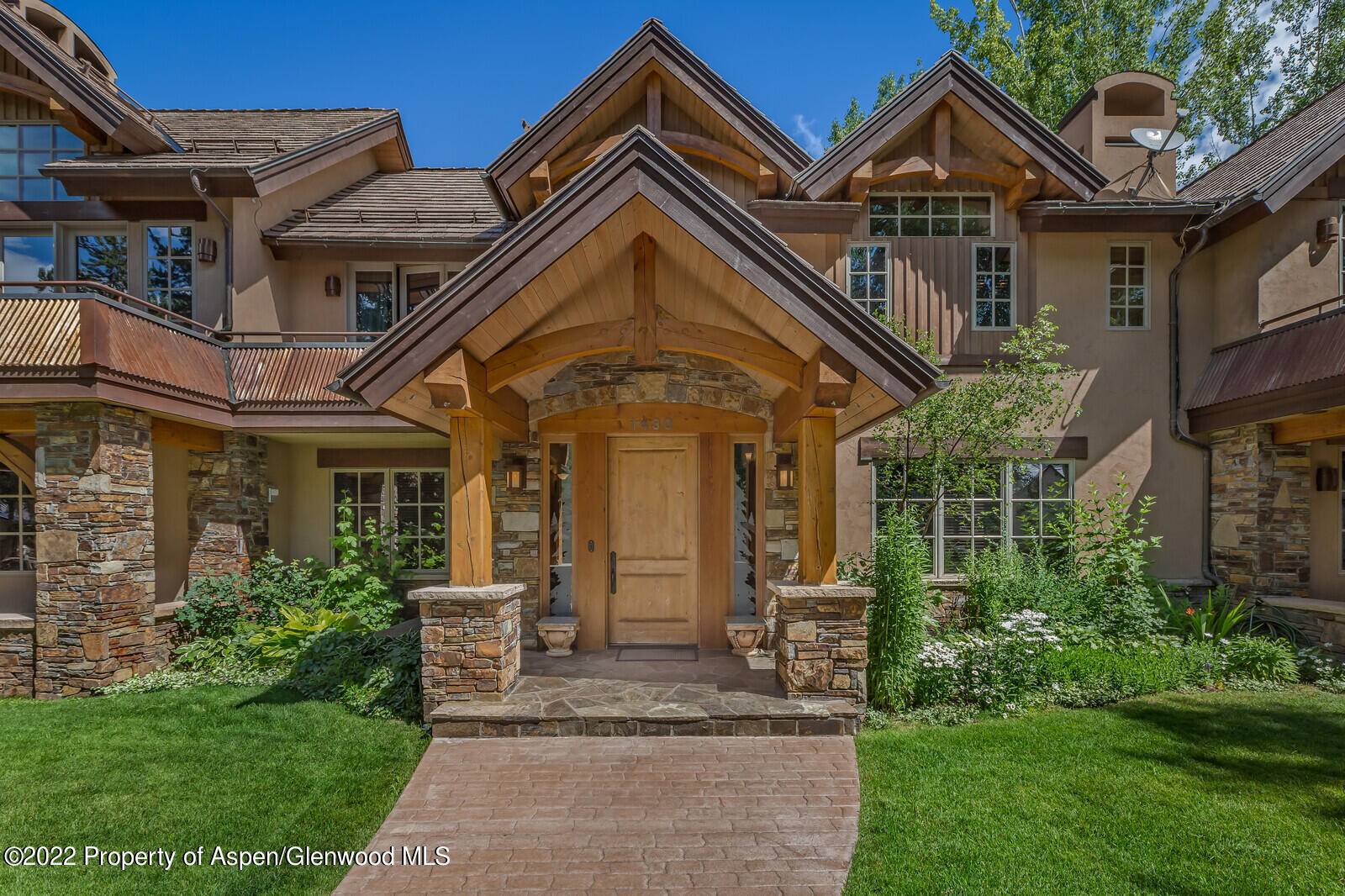 Newly updated West Aspen home with bright upper level living, cathedral ceilings, and wood trusses.