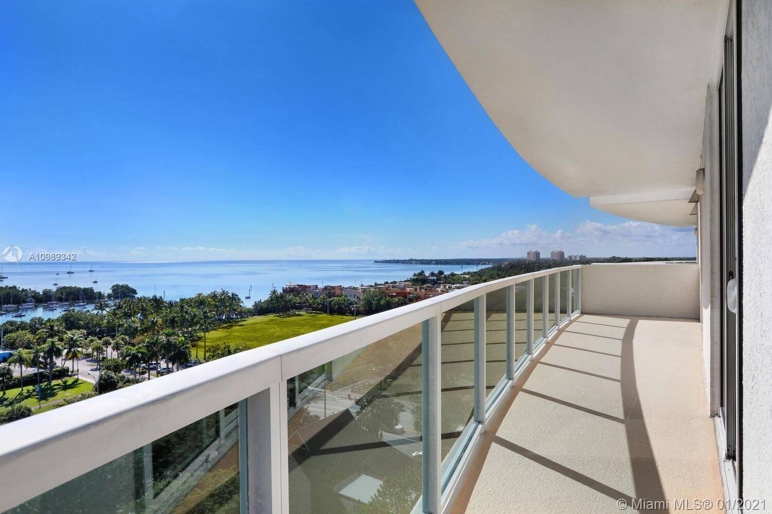 Enjoy spectacular views of Biscayne Bay from this light filled residence in the heart of the Coconut Grove village.