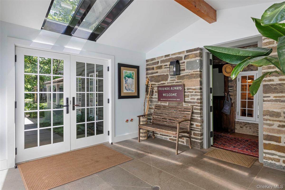Welcoming foyer with skylights and original stone walls