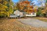 Welcome to 27 Winding Lane — a beautifully renovated home surrounded by vibrant seasonal color, featuring a fresh exterior, new deck, and inviting cur