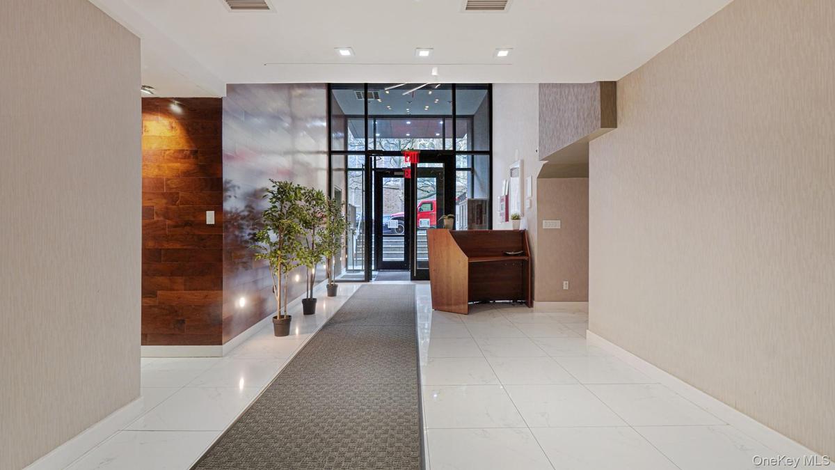 Lobby featuring wallpapered walls and floor to ceiling windows