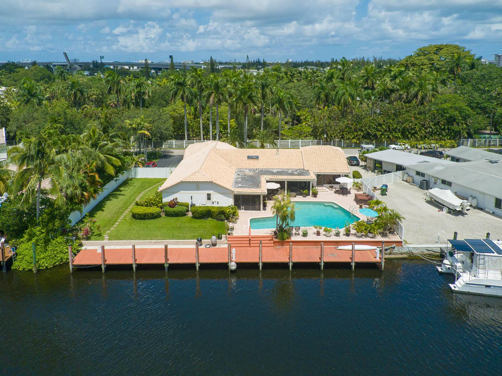 BOATERS PARADISE FOUND ! Luxury residence located in a truly tropical setting along Fort Lauderdale's New River.