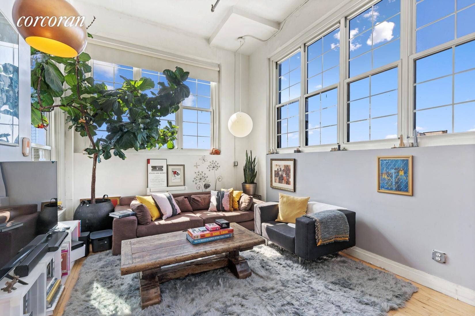 With a footprint of almost 1200 square feet and yards of windows facing Manhattan, this quintessential loft with 13' ceilings and industrial accents truly epitomizes New York living.