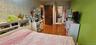 Bedroom with light wood-type flooring and wallpapered walls