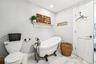Full bath featuring a freestanding bath and marble look tiles
