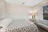 Bedroom featuring a wainscoted wall and a baseboard heating unit
