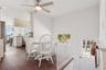 Dining space with ceiling fan, a healthy amount of sunlight, and dark hardwood / wood-style flooring