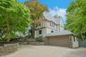 This impressive Tudor with a slate roof offers a two car attached garage with heated driveway, while the expansive roof deck above creates a unique ou