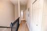 Beautiful hallway with clean lines creates a seamless flow to full bathroom and bedroom.