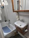 Full bath featuring shower / bath combination and a sink