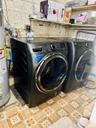 Laundry room with electric water heater and washer and dryer