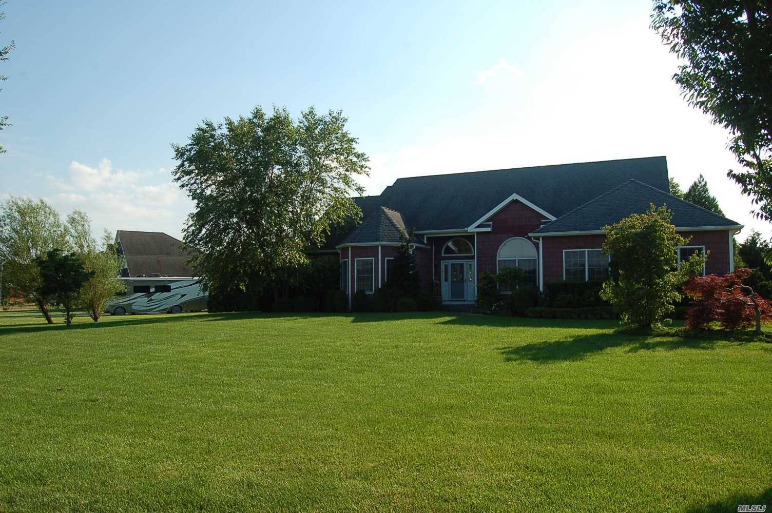 This Post modern ranch is located on 1 acre next to horse farm.