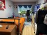 Bedroom with a wall mounted AC and light hardwood / wood-style flooring
