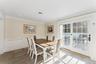 Dining space featuring wainscoted walls and crown molding.