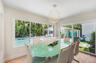 Enjoy dining with family and friends in this light and bright dining area with tropical pool views