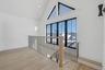 Beautiful second floor landing with large windows providing natural light.