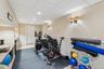 Exercise room featuring a wainscoted wall, a paneled ceiling, and recessed lighting