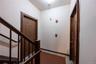Foyer featuring light tile patterned floors and stairway