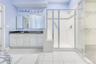 Full Master Bathroom featuring double vanity, light tile patterned floors, a stall shower, and a spacious closet