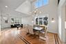 Dining area featuring a chandelier, light wood finished floors, a towering ceiling, and recessed lighting