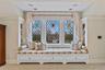 Sitting room with built in features and stained glass.
