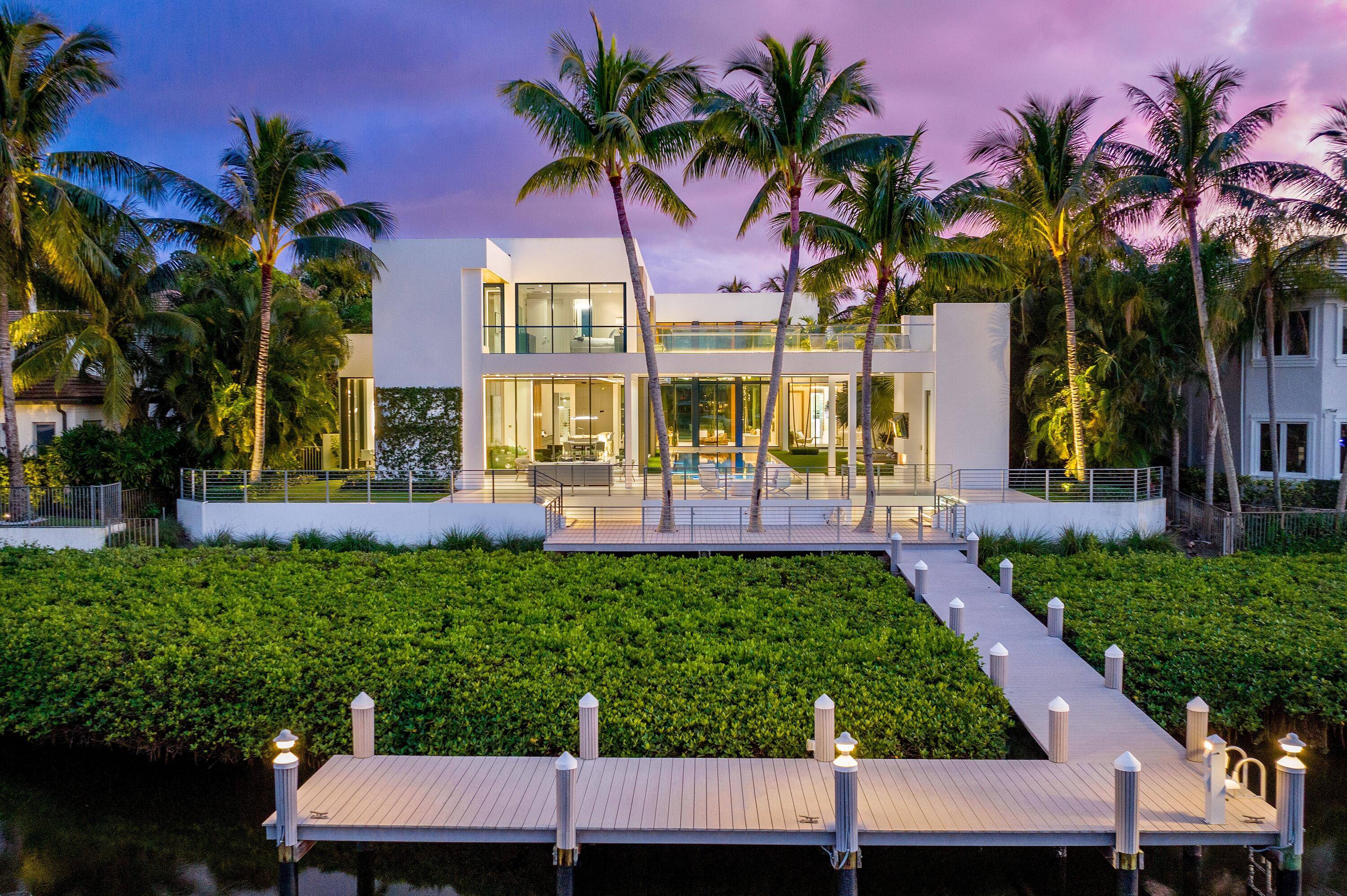 Welcome to 160 Spyglass Ln, a remarkably contemporary waterfront estate nestled among the elegance of Jupiter's coveted Admiral's Cove.