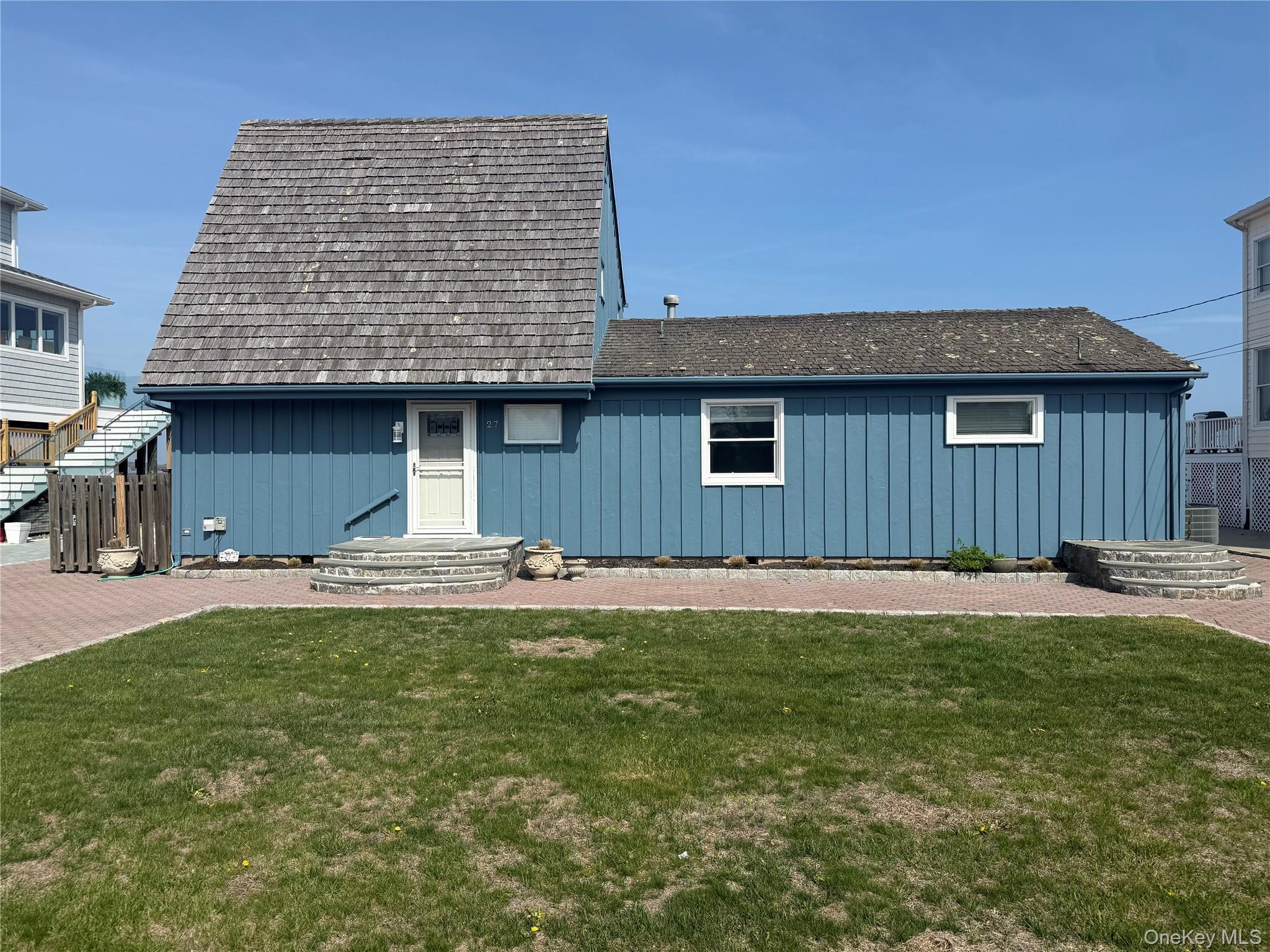 View of front of home with board and batten siding and a front lawn
