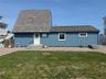 View of front of home with board and batten siding and a front lawn