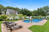 View of swimming pool featuring a patio area, a fenced backyard, and a water slide