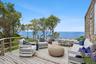 Wooden deck featuring an outdoor living space, a water view, and outdoor dining area