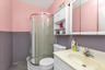 Bathroom featuring vanity, an enclosed shower, toilet, and tile patterned flooring