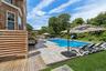 View of swimming pool with a patio and a deck